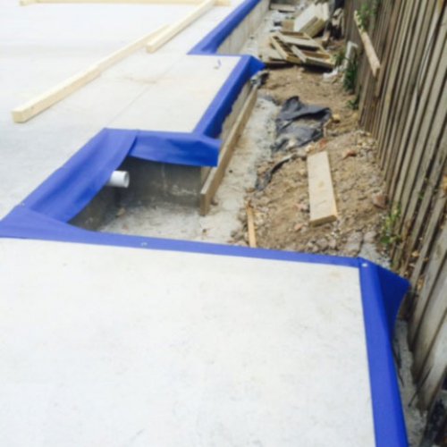 HomeGuard Blue sheets installed to the edge of the slab 